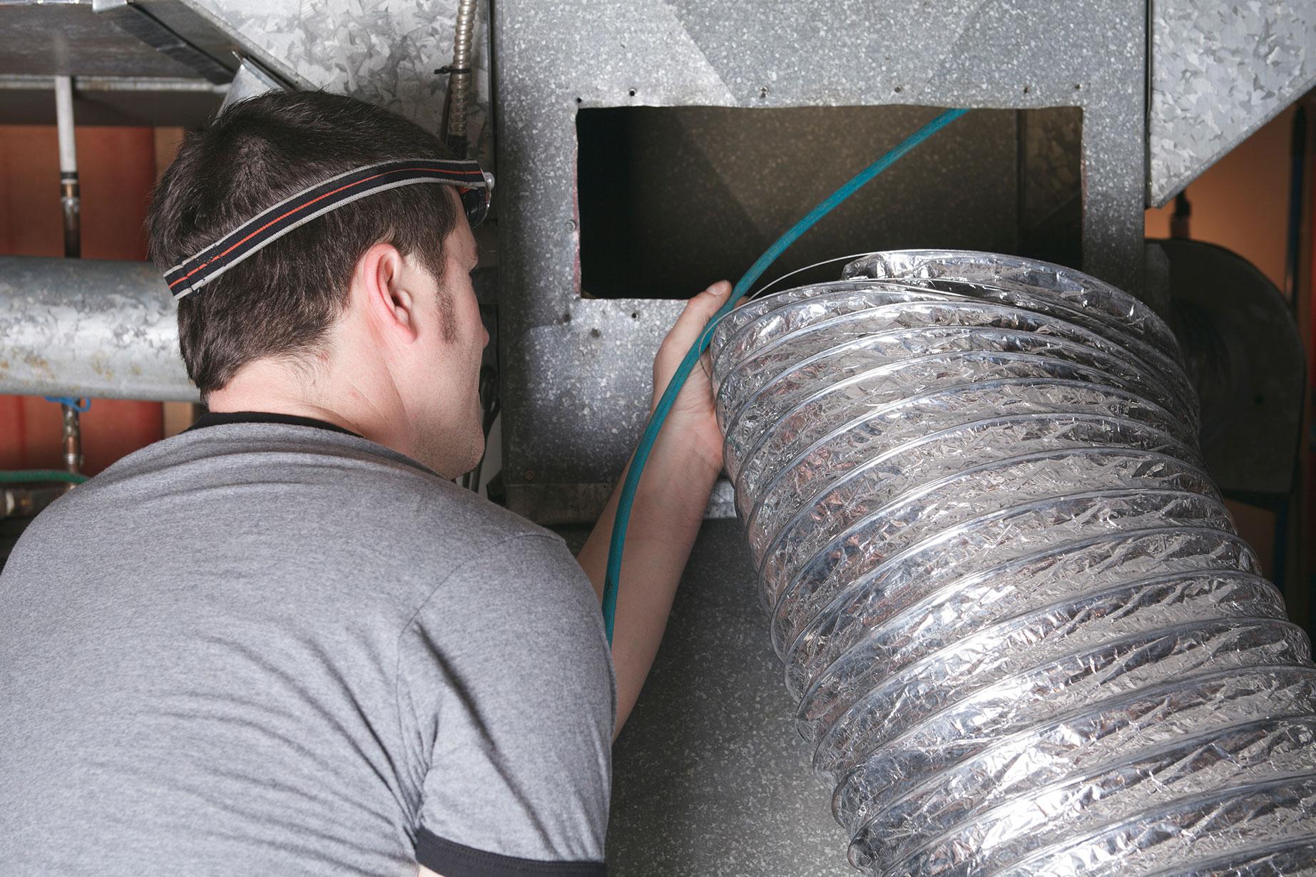 technician performing duct cleaning services